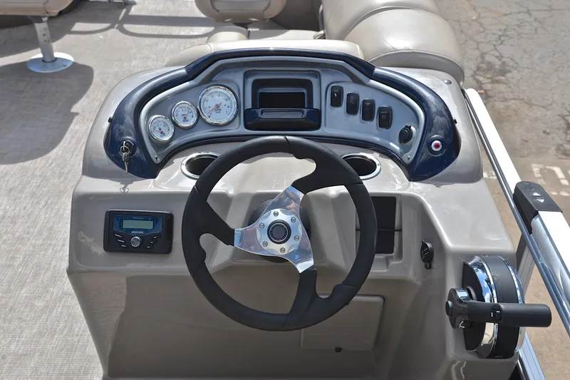Slide: The Image of 2023 Sun Tracker Fishin' Barge 20 DLX dashboard with steering wheel and control panel. - 26