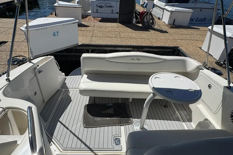 Slide: The Image of 2005 Sea Ray 280 Sundancer boat interior with seating and table at dock. - 19