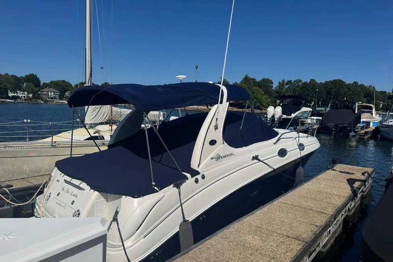 Slide: The Image of 2005 Sea Ray 280 Sundancer docked at marina under clear blue sky. - 2