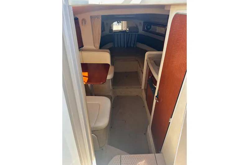 Slide: The Image of Interior view of 2005 Sea Ray 280 Sundancer cabin with seating and wood accents. - 26