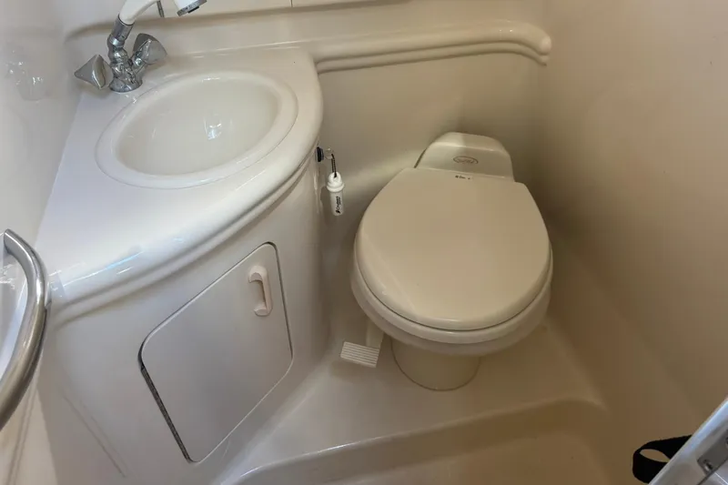 Slide: The Image of Compact bathroom in 2005 Sea Ray 280 Sundancer boat with sink and toilet. - 31