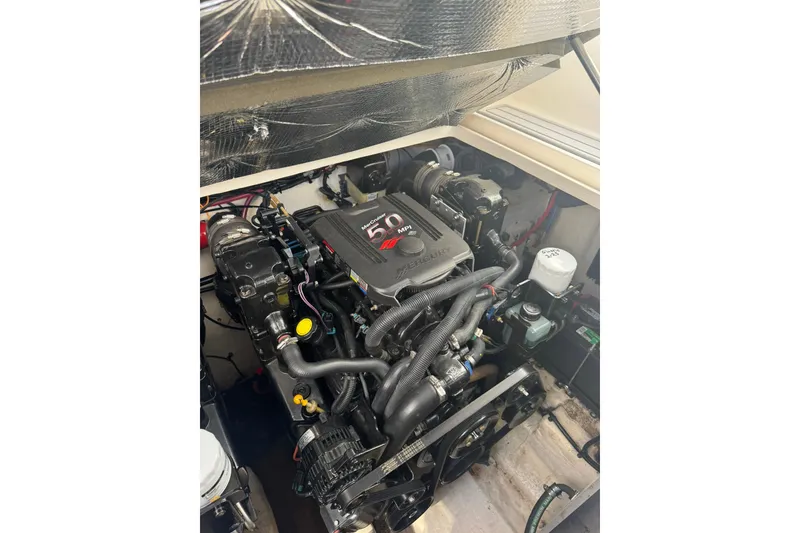 Slide: The Image of Engine compartment of a 2005 Sea Ray 280 Sundancer boat, featuring a MerCruiser 5.0 MPI engine. - 34