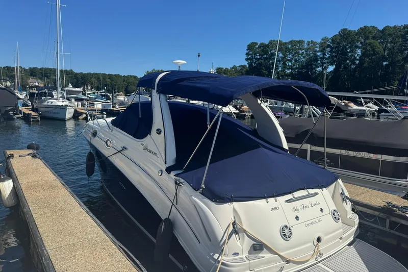 Slide: The Image of 2005 Sea Ray 280 Sundancer docked at marina with blue canopy. - 4