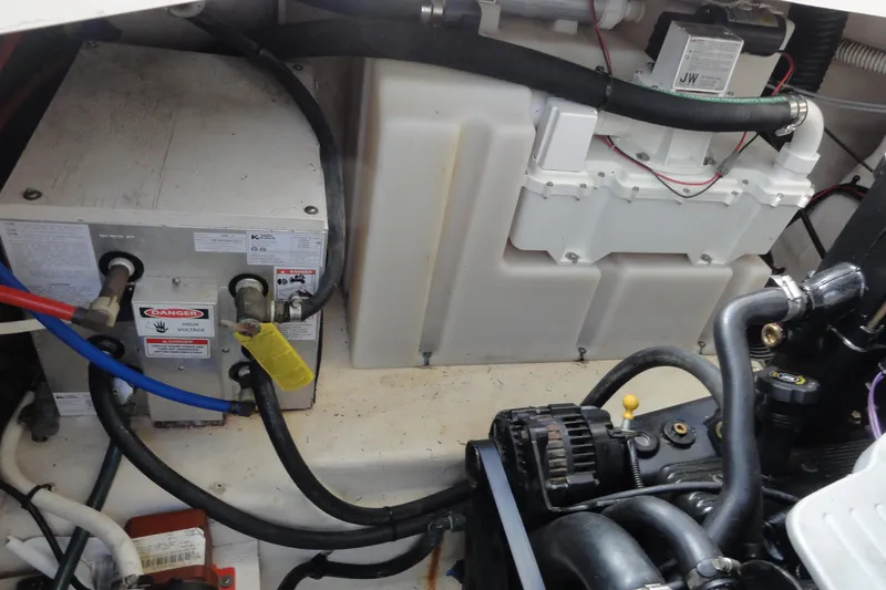 Slide: The Image of Engine compartment of a 2010 Sea Ray 260 Sundancer, showing electrical and mechanical components. - 14