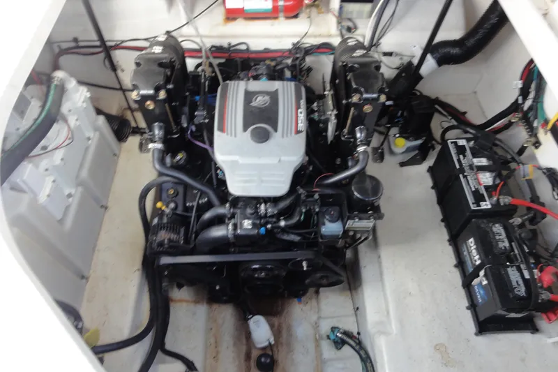 Slide: The Image of Engine compartment of a 2010 Sea Ray 260 Sundancer with visible batteries and wiring. - 15