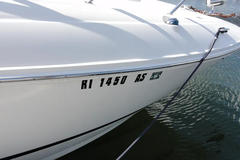 Slide: The Image of 2010 Sea Ray 260 Sundancer boat docked with registration number RI 1450 AS. - 17