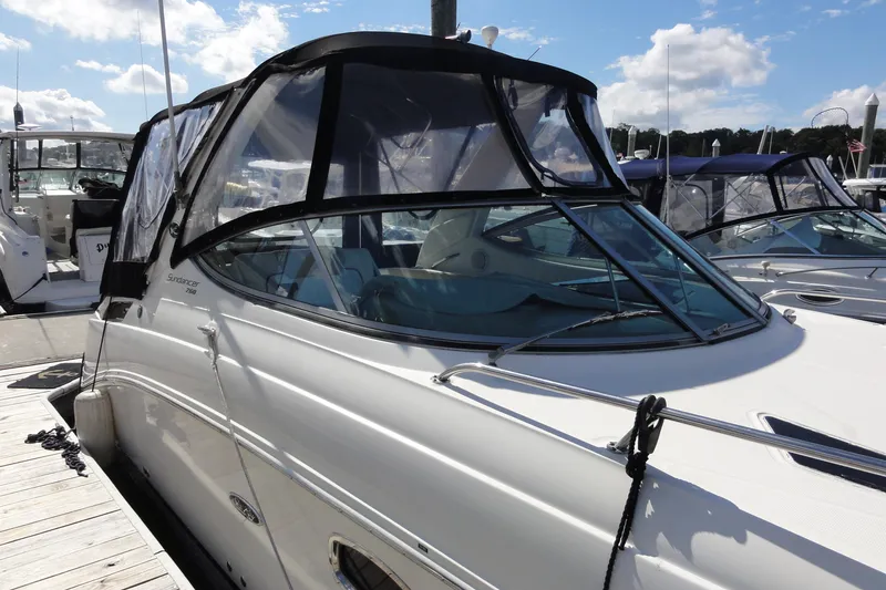 Slide: The Image of 2010 Sea Ray 260 Sundancer boat docked at marina under clear blue sky. - 18