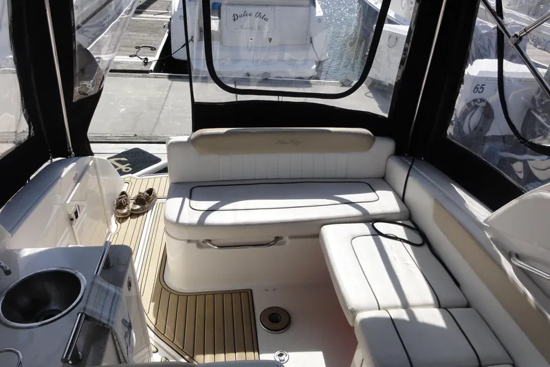 Slide: The Image of Interior of a 2010 Sea Ray 260 Sundancer boat with white seating and a small sink. - 4