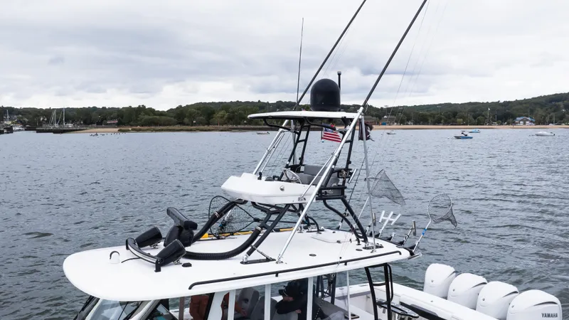 Slide: The Image of 2017 Everglades 435 CC boat on water, featuring advanced navigation equipment and multiple antennas. - 11