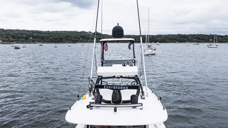 Slide: The Image of 2017 Everglades 435 CC boat on a lake with distant shoreline and cloudy sky. - 12