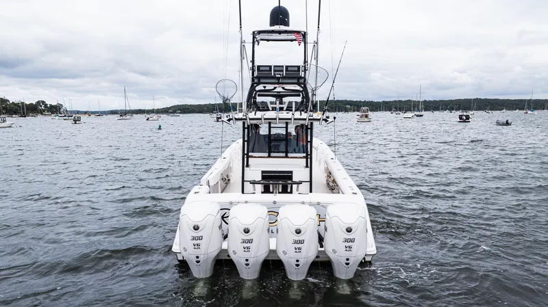 Slide: The Image of 2017 Everglades 435 CC boat with four engines on open water. - 13