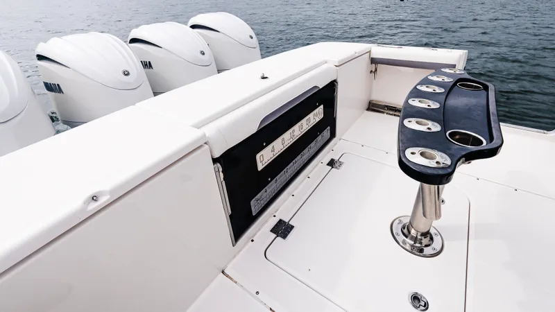 Slide: The Image of 2017 Everglades 435 CC boat deck with rod holders and multiple outboard engines. - 18