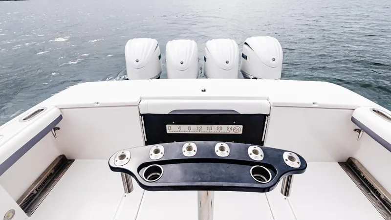 Slide: The Image of 2017 Everglades 435 CC boat with four powerful outboard engines on open water. - 19