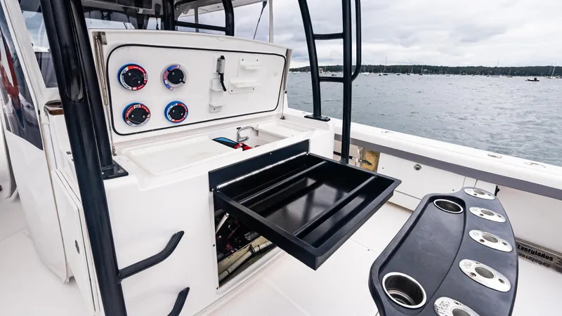 Slide: The Image of 2017 Everglades 435 CC boat interior with open storage drawer and control panel. - 21
