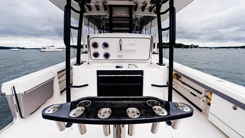 Slide: The Image of 2017 Everglades 435 CC boat interior with fishing rod holders and control panel. - 23