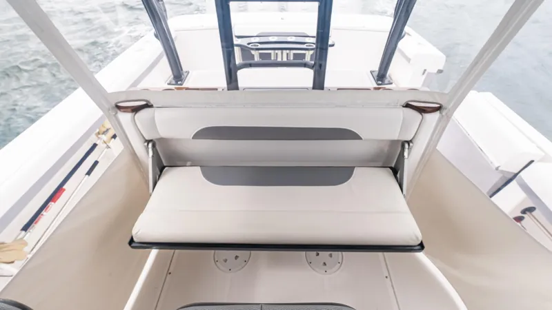 Slide: The Image of 2017 Everglades 435 CC boat interior with white seating and helm view. - 25