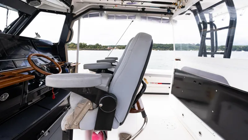 Slide: The Image of Interior of 2017 Everglades 435 CC boat with steering wheel and seating. - 26