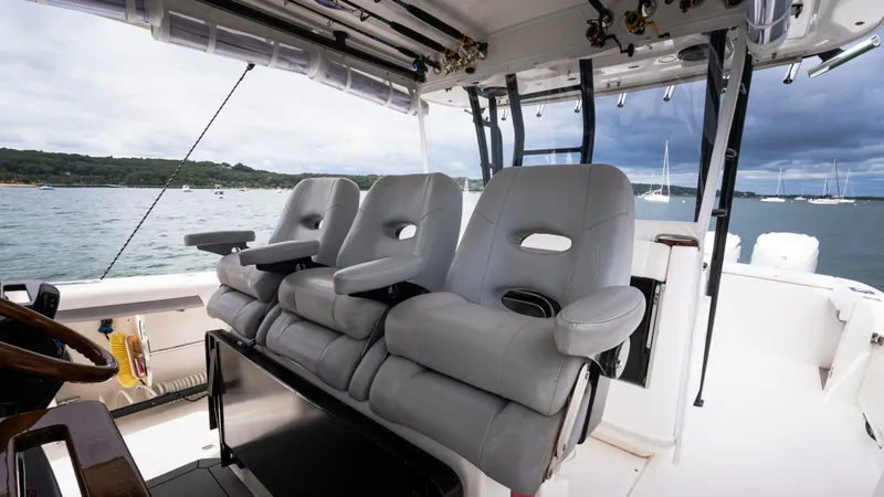 Slide: The Image of 2017 Everglades 435 CC boat interior with plush seating and scenic water view. - 27