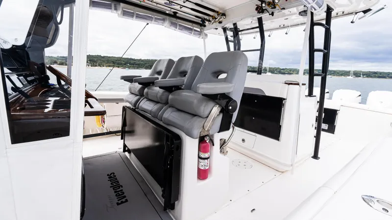 Slide: The Image of 2017 Everglades 435 CC boat interior with gray seating and safety equipment. - 28