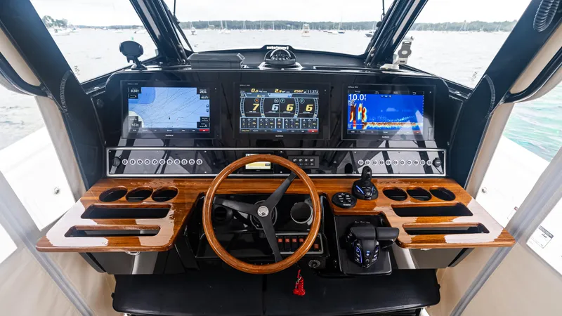 Slide: The Image of Helm of 2017 Everglades 435 CC boat with advanced navigation displays and controls. - 30