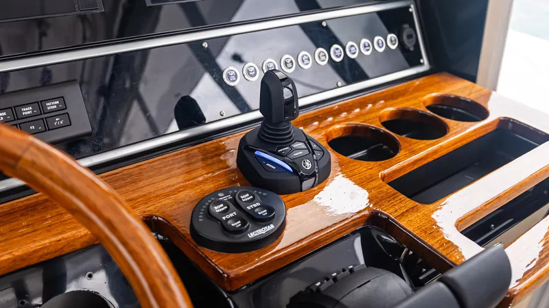Slide: The Image of Control panel of 2017 Everglades 435 CC boat with joystick and wooden finish. - 34