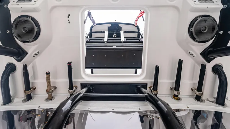 Slide: The Image of 2017 Everglades 435 CC boat interior with speakers and rod holders. - 35