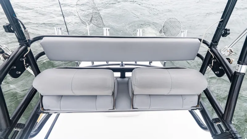 Slide: The Image of 2017 Everglades 435 CC boat seating with fishing rod holders on a calm sea. - 36