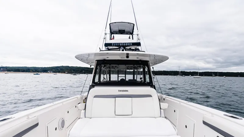 Slide: The Image of 2017 Everglades 435 CC boat on open water, showcasing sleek design and spacious deck. - 41