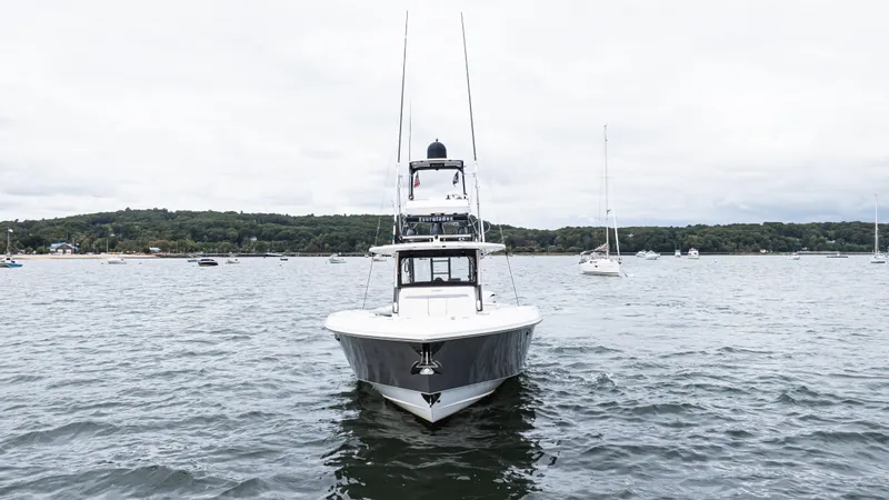 Slide: The Image of 2017 Everglades 435 CC boat on a calm lake with distant shoreline. - 9