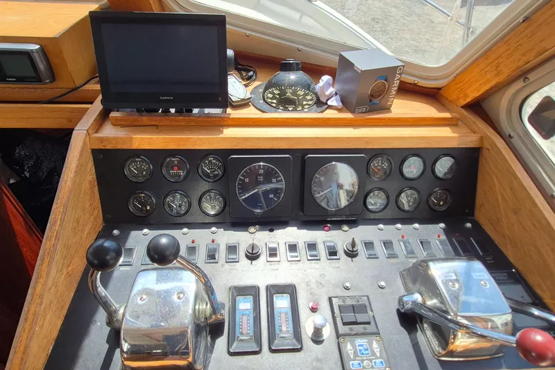 Slide: The Image of Control panel of a 1990 Sabreline 36 Fast Trawler with gauges and navigation equipment. - 13