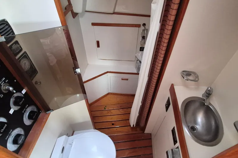 Slide: The Image of 1990 Sabreline 36 Fast Trawler bathroom with wooden flooring and compact sink. - 21