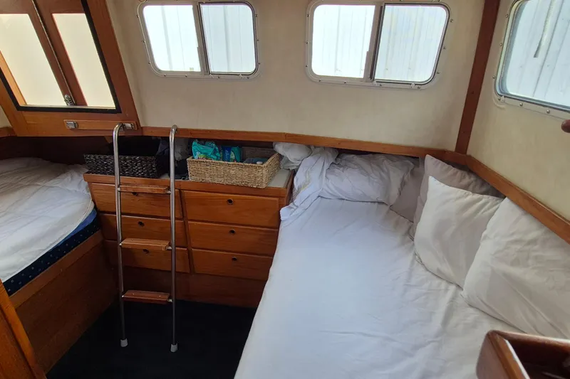 Slide: The Image of Cozy cabin interior of 1990 Sabreline 36 Fast Trawler with beds and storage. - 25