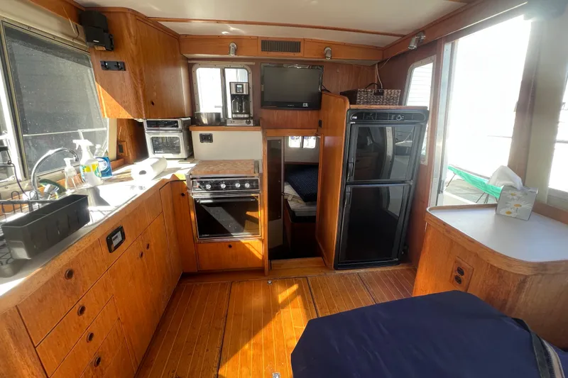 Slide: The Image of Interior of 1990 Sabreline 36 Fast Trawler with kitchen and dining area. - 36