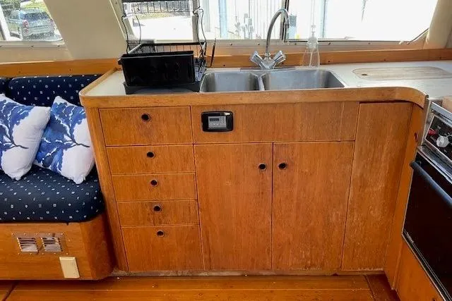Slide: The Image of Interior of 1990 Sabreline 36 Fast Trawler with wooden cabinetry and dual sink. - 38