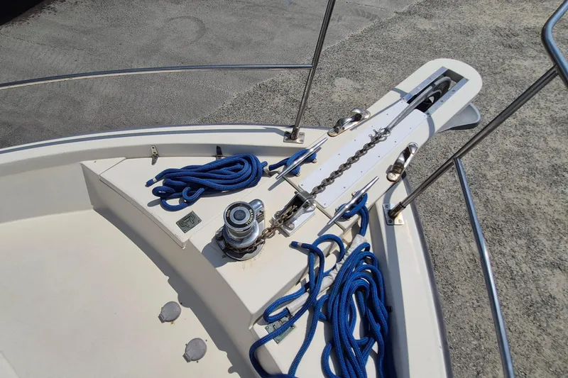 Slide: The Image of Bow of 1990 Sabreline 36 Fast Trawler with anchor chain and blue ropes. - 45