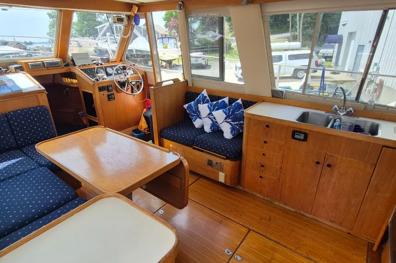 Slide: The Image of Interior of 1990 Sabreline 36 Fast Trawler with wood finish and cozy seating area. - 5