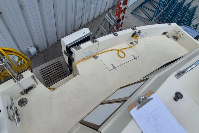Slide: The Image of 1990 Sabreline 36 Fast Trawler deck with yellow cable and clipboard. - 52