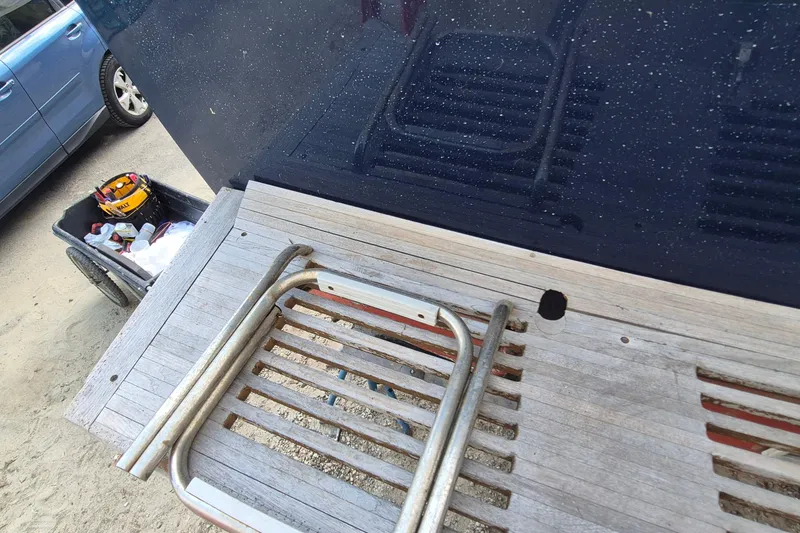 Slide: The Image of 1990 Sabreline 36 Fast Trawler swim platform with ladder and maintenance tools nearby. - 53