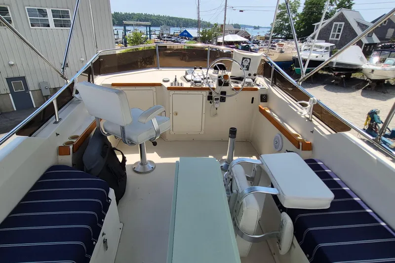 Slide: The Image of Flybridge of 1990 Sabreline 36 Fast Trawler with seating and steering wheel. - 59