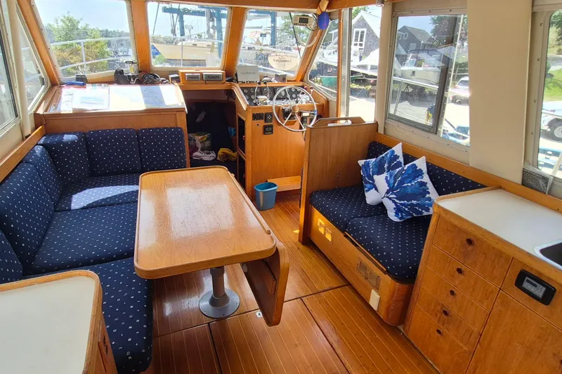 Slide: The Image of Interior of 1990 Sabreline 36 Fast Trawler with blue seating and wooden accents. - 7