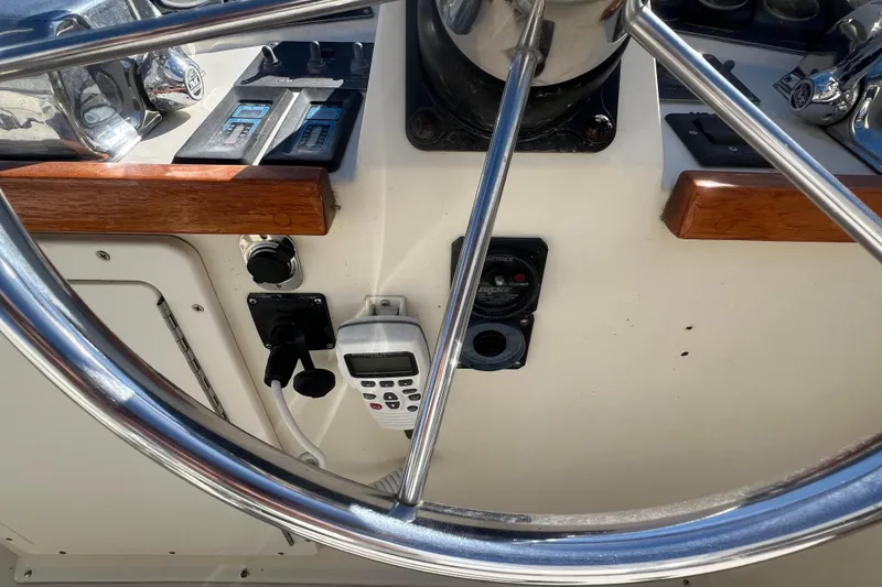 Slide: The Image of 1990 Sabreline 36 Fast Trawler helm with steering wheel and control panel. - 78