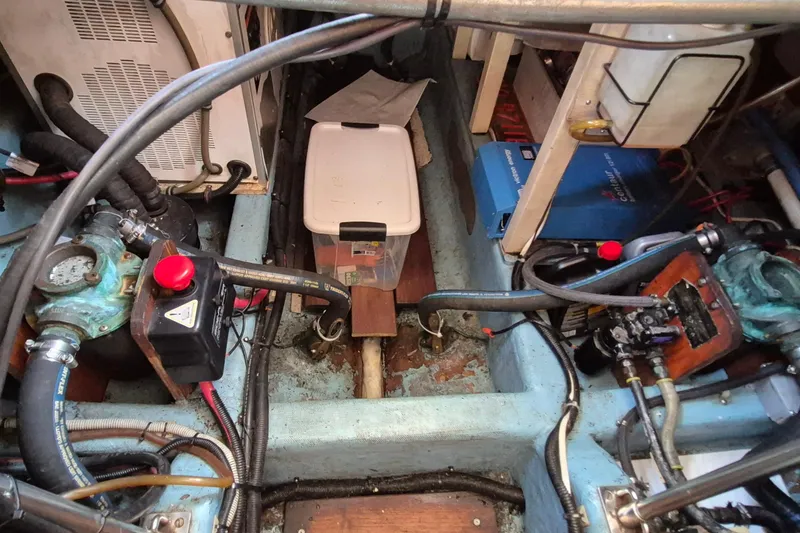 Slide: The Image of Engine room of 1990 Sabreline 36 Fast Trawler with mechanical components and storage. - 83