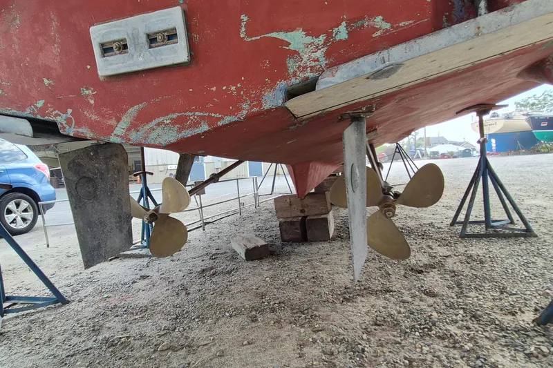 Slide: The Image of 1990 Sabreline 36 Fast Trawler under maintenance, showing propellers and rudder. - 90