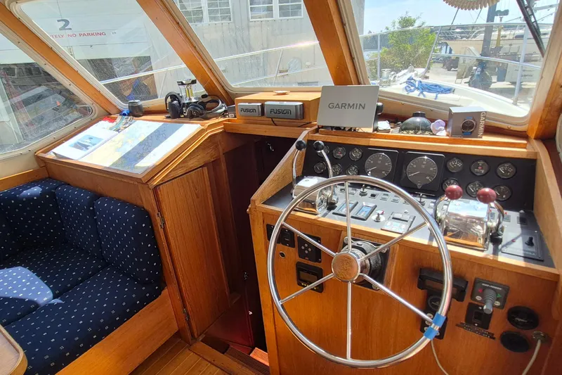 Slide: The Image of 1990 Sabreline 36 Fast Trawler helm with navigation equipment and wooden interior. - 10