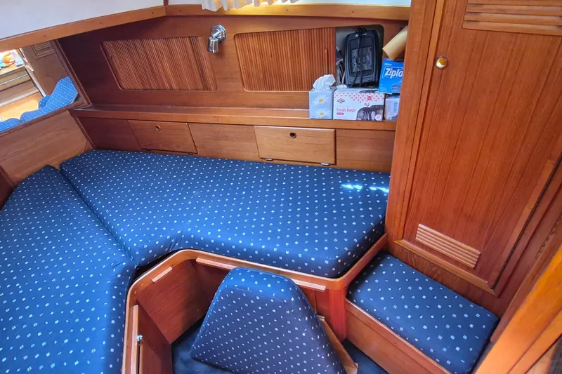 Slide: The Image of Cozy cabin interior of 1990 Sabreline 36 Fast Trawler with blue patterned cushions. - 18