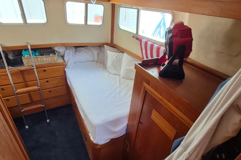 Slide: The Image of Cozy cabin interior of 1990 Sabreline 36 Fast Trawler with bed and storage. - 28