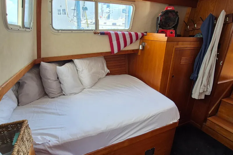 Slide: The Image of Cozy cabin interior of 1990 Sabreline 36 Fast Trawler with bed and wooden furnishings. - 29