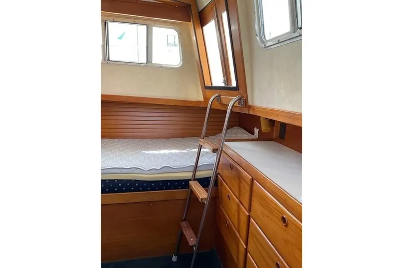 Slide: The Image of Cozy cabin interior of 1990 Sabreline 36 Fast Trawler with wooden furnishings and ladder. - 32