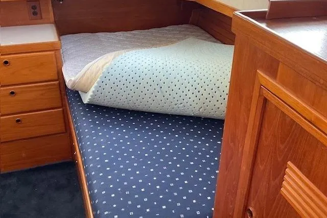 Slide: The Image of Cozy cabin bed in 1990 Sabreline 36 Fast Trawler with wooden cabinetry. - 33