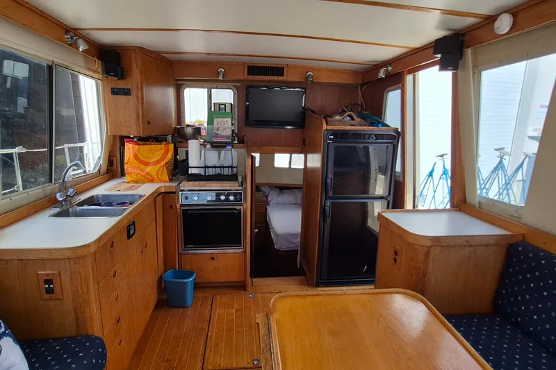 Slide: The Image of Interior of 1990 Sabreline 36 Fast Trawler with kitchen and dining area. - 35
